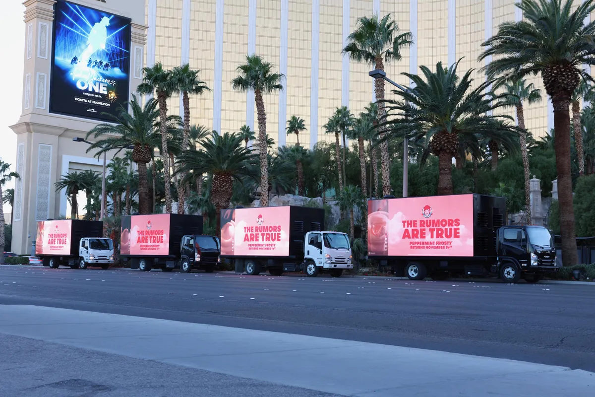 Fleet of mobile billboard advertising trucks lined up along the Las Vegas Strip during daytime showing coordinated campaign